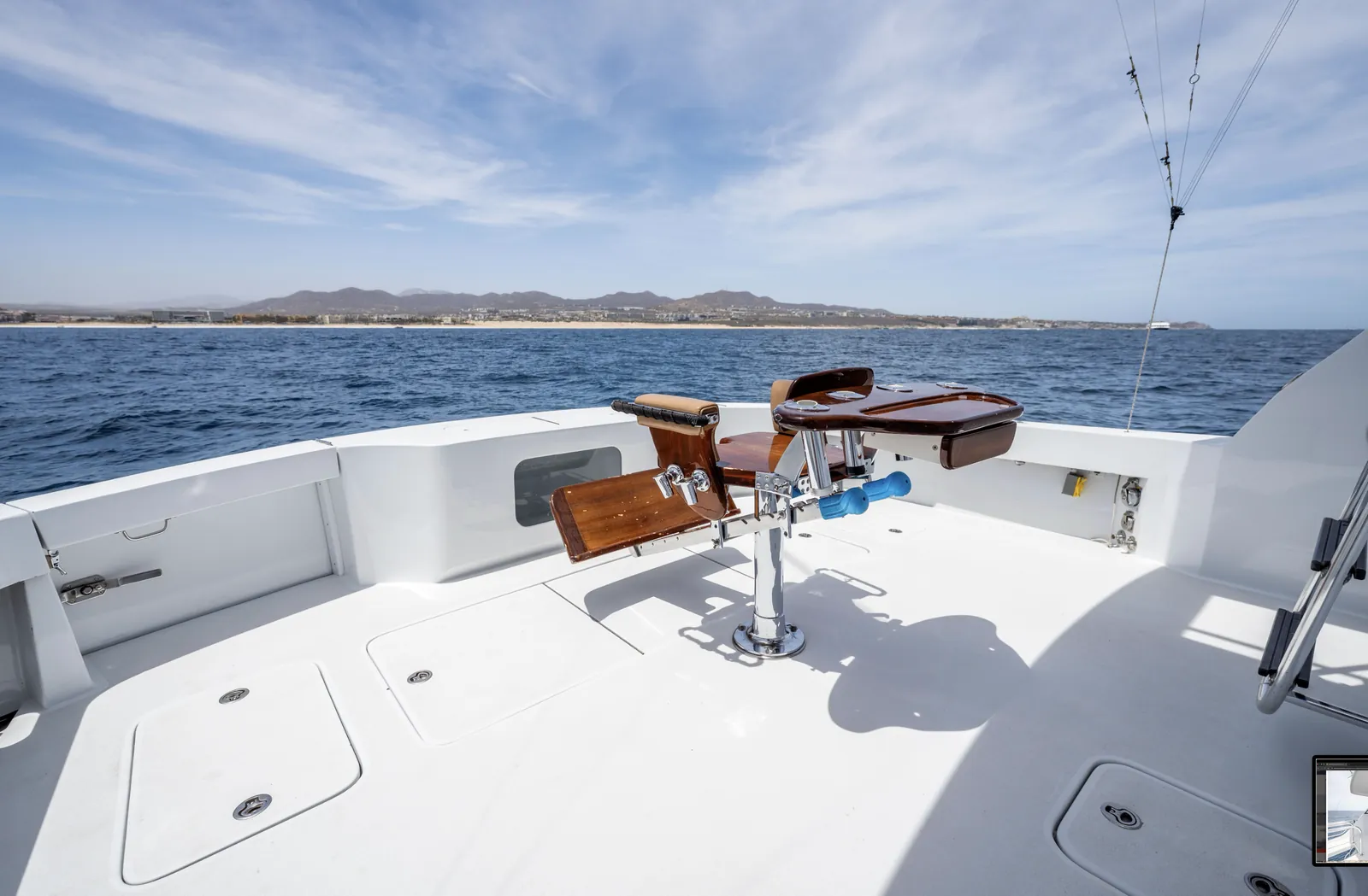 Fighting chair on the stern of the 65 foot Hatteras with the Cabo coastline astern