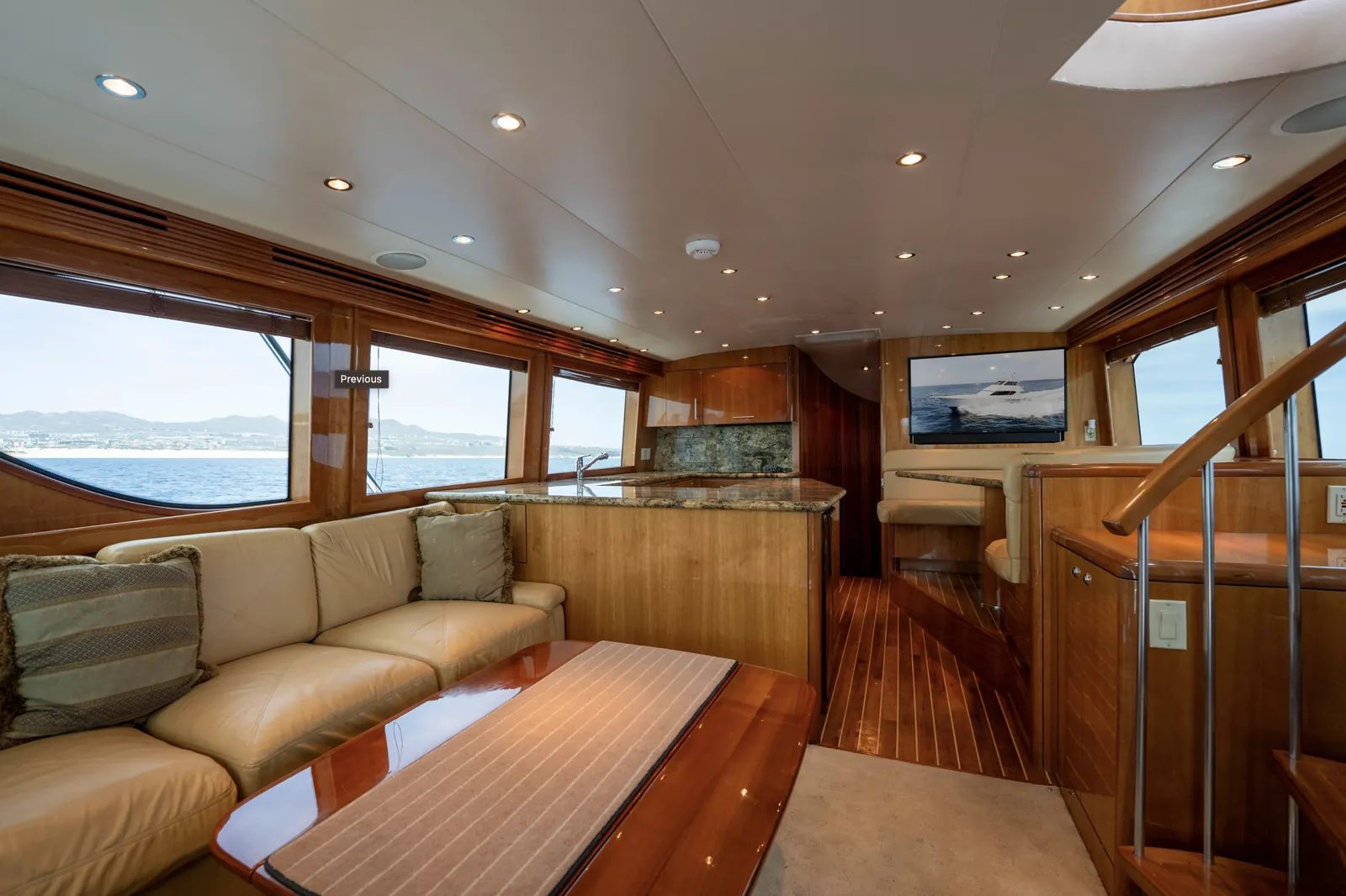 Teak and cream leather salon of the 65 foot Hatteras with panoramic ocean views